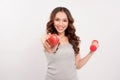 Young fitness model woman athlete in sportswear with red dumbbell and green apple. Healthy life bodybuilding lifestyle concept Royalty Free Stock Photo