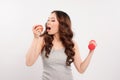 Young fitness model woman athlete in sportswear with red dumbbell and green apple. Royalty Free Stock Photo