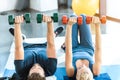 Young fitness people exercising with dumbbells at fitness studio Royalty Free Stock Photo