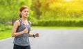 Young fitness sport woman running on the road in the morning, Young fitness sportswoman runner running on tropical park trail. Peo Royalty Free Stock Photo