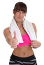 Young fitness sports woman with towel showing thumbs up isolated Royalty Free Stock Photo