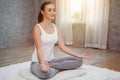 Young fitness woman in casual wear practicing yoga with mat on floor in bedroom at home in Morning . sport girl doing meditating Royalty Free Stock Photo