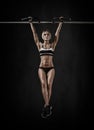 Young fitness woman chin-up on horizontal bar