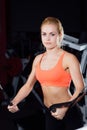 Young fitness woman demonstrate crossover exercises. The pectoral muscles, hard training with exercise-machine Cable Royalty Free Stock Photo