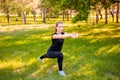 Young fitness woman doing lunges exercises to train leg muscles. An active girl does an exercise with a lunge on one leg in front