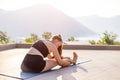 Young fitness woman doing stretching against stunning mountain view during her morning yoga routine Royalty Free Stock Photo