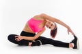 Fitness woman doing stretching exercise on white background