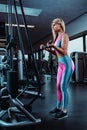 Young fitness woman execute exercise with exercise-machine Cable Crossover in gym Royalty Free Stock Photo