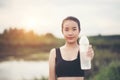 Young fitness woman hand holding water bottle after running exercise Royalty Free Stock Photo