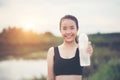 Young fitness woman hand holding water bottle after running Royalty Free Stock Photo