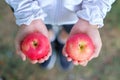 Young fitness woman holding in hands red apple