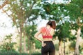 Young fitness woman holding her sports injury shoulder and neck, muscle painful during training. Asian runner female having body Royalty Free Stock Photo