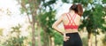 Young fitness woman holding her sports injury shoulder and neck, muscle painful during training. Asian runner female having body Royalty Free Stock Photo