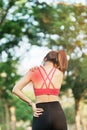 Young fitness woman holding her sports injury shoulder and neck, muscle painful during training. Asian runner female having body Royalty Free Stock Photo