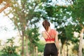 Young fitness woman holding her sports injury shoulder and neck, muscle painful during training. Asian runner female having body Royalty Free Stock Photo