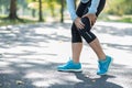 Young fitness woman holding his sports leg injury, muscle painful during training. Asian runner having calf ache and problem after Royalty Free Stock Photo