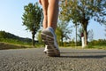 Young fitness woman legs running on asphalt road Royalty Free Stock Photo