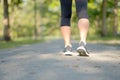 Young fitness woman legs walking in the park outdoor, female runner running on the road outside, asian athlete jogging and exercis Royalty Free Stock Photo