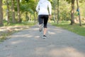 Young fitness woman legs walking in the park outdoor, female runner running on the road outside, asian athlete jogging and exercis Royalty Free Stock Photo