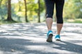 Young fitness woman legs walking in the park outdoor, female runner running on the road outside, asian athlete jogging and exercis Royalty Free Stock Photo