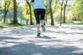 Young fitness woman legs walking in the park outdoor, female runner running on the road outside, asian athlete jogging and exercis Royalty Free Stock Photo