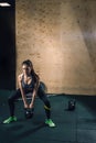 Young fitness woman lifting heavy weight kettle bell at gym Royalty Free Stock Photo