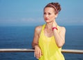 Young fitness woman looking into distance at embankment Royalty Free Stock Photo