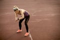 Young fitness woman looking at her smart watch while taking a br