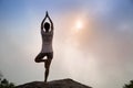 Fitness woman meditating on sunrise mountain peak Royalty Free Stock Photo