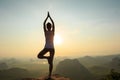 woman meditating on sunrise mountain peak Royalty Free Stock Photo