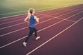 Young fitness woman runner running on stadium track. Athletics at the stadium. Royalty Free Stock Photo