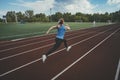 Young fitness woman runner running on stadium track. Athletics at the stadium. Royalty Free Stock Photo