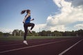 Young fitness woman runner running on stadium track. Athletics at the stadium. Royalty Free Stock Photo