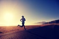 Young fitness woman runner running on sunrise seaside trail Royalty Free Stock Photo