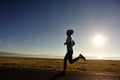 young fitness woman runner running on sunrise seaside trail Royalty Free Stock Photo