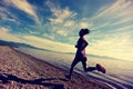 Young fitness woman runner running on sunrise seaside trail Royalty Free Stock Photo