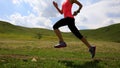 Fitness woman runner running on sunset grassland trail Royalty Free Stock Photo