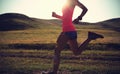 woman runner running on sunset trail