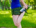 Young fitness woman runner stretching legs before run. Close up Royalty Free Stock Photo