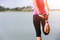 Young fitness woman runner stretching legs before run on park. Royalty Free Stock Photo