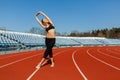 Young fitness woman runner warm up before running on track. Morning exercises at summer Royalty Free Stock Photo