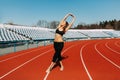 Young fitness woman runner warm up before running on track. Morning exercises at summer Royalty Free Stock Photo