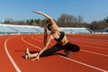 Young fitness woman runner warm up before running on track. Morning exercises at summer Royalty Free Stock Photo