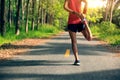 Woman runner warming up before run Royalty Free Stock Photo