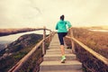 Woman running on morning tropical forest trail