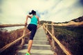 Woman running on morning tropical forest trail