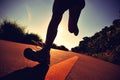 Young fitness woman running on sunrise seaside trail Royalty Free Stock Photo