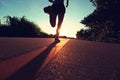 Young fitness woman running on sunrise seaside trail Royalty Free Stock Photo