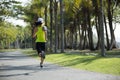 young fitness woman running at tropical park Royalty Free Stock Photo