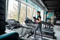 young fitness woman with slim body type is doing exercises with help exercise machines in gym. Royalty Free Stock Photo